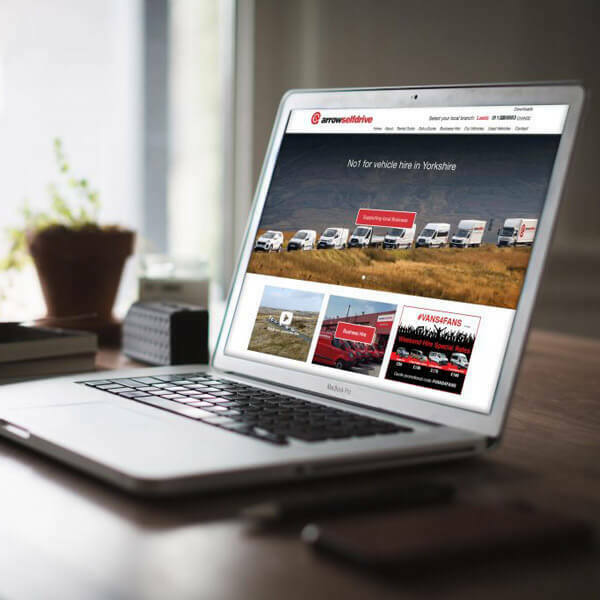 Laptop displaying the Arrow Self Drive website with the headline “No1 for vehicle hire in Yorkshire”.