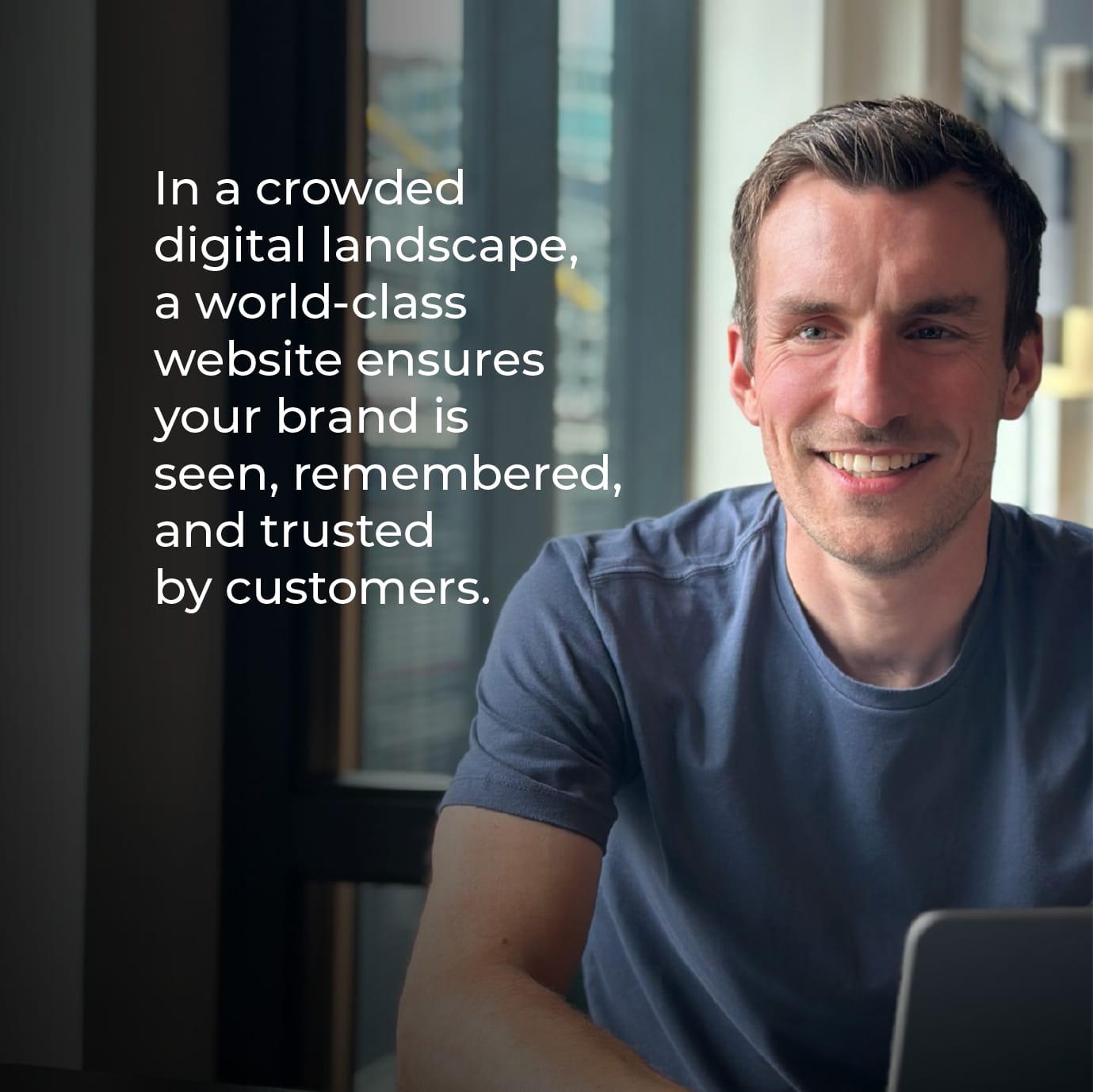 Smiling man beside the quote: “In a crowded digital landscape, a world-class website ensures your brand is seen, remembered, and trusted by customers.”