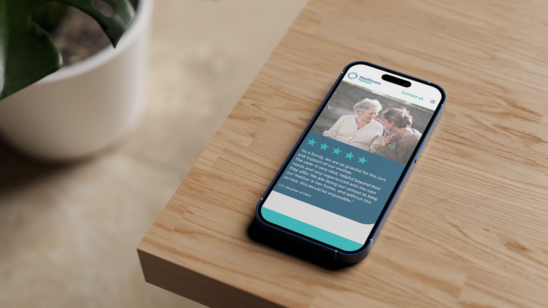 Smartphone displaying a home care website with an elderly couple and five-star rating.