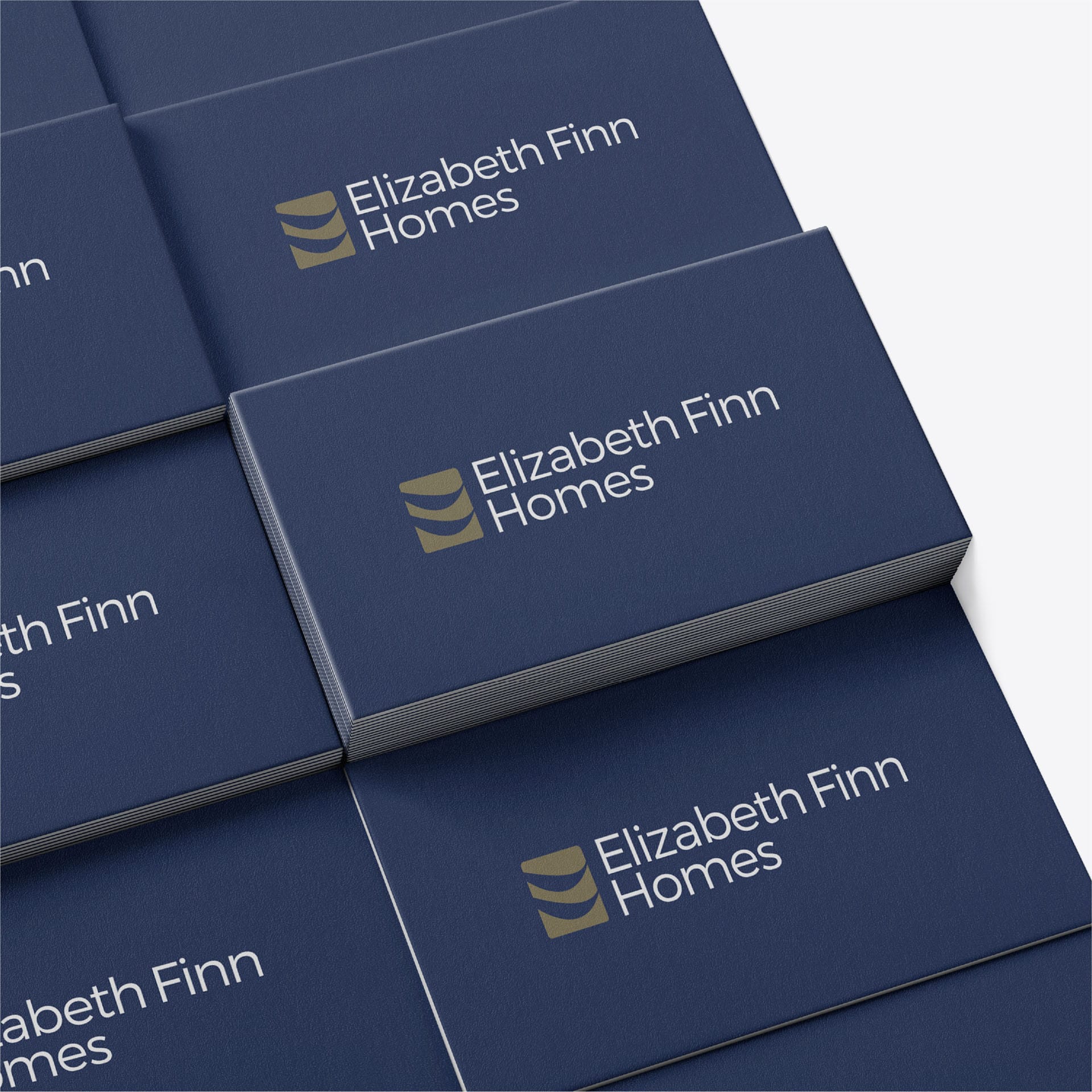 Stacked navy presentation boxes with the Elizabeth Finn Homes logo.
