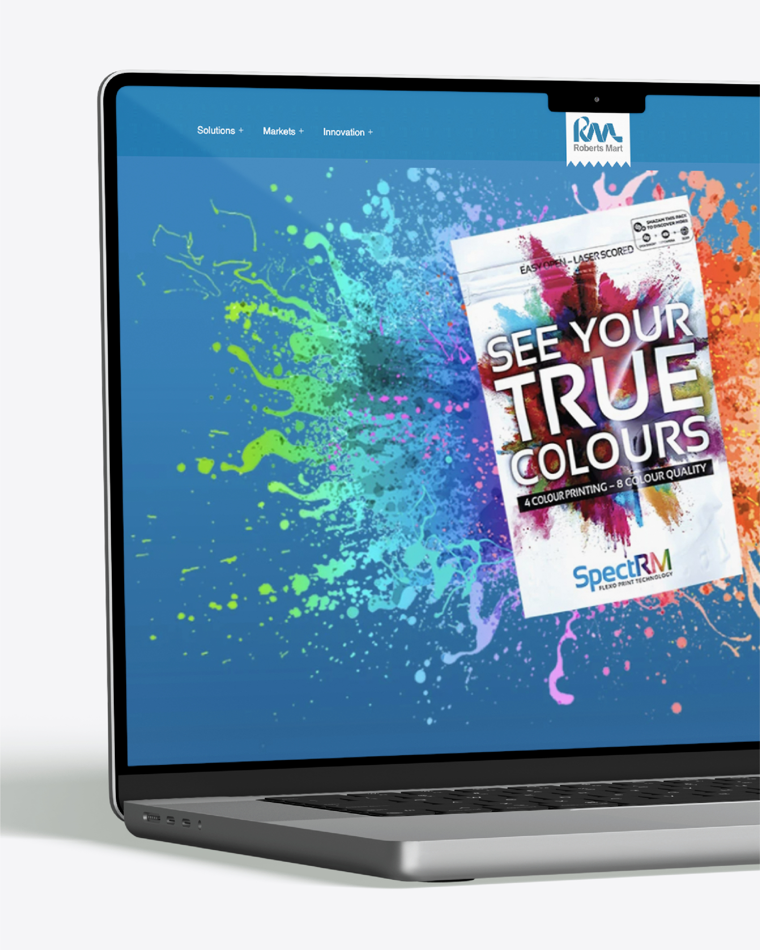Laptop displaying Roberts Mart with a “SEE YOUR TRUE COLOURS” SpectRM print advert.